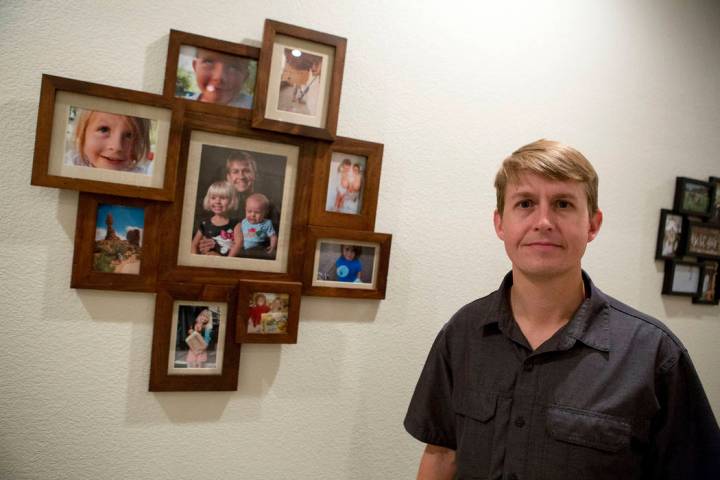 Shane Peterson stands next to images of his daughters at his home in Henderson on Nov. 15, 2017 ...