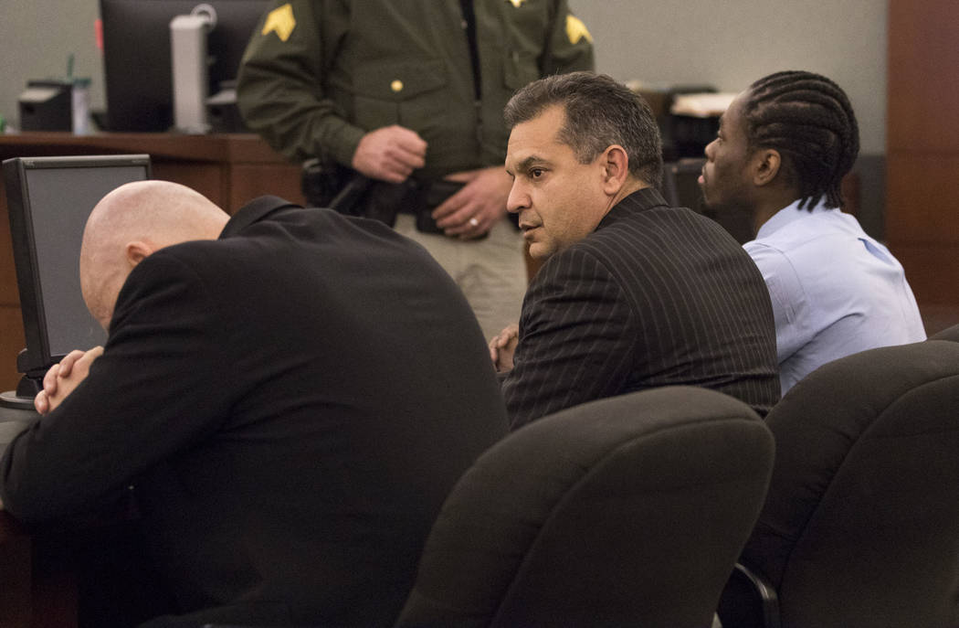 Defense attorney's Tony Sgro, from left, bows his head as Christopher Oram look at the jury aft ...