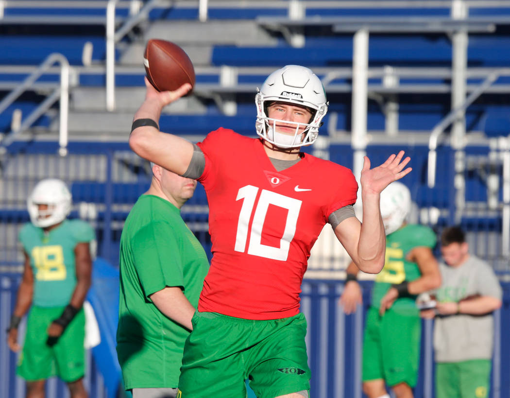 Oregon Ducks quarterback Justin Herbert (10) throws a ball during a football practice at Bishop Gorman High School in Las Vegas, Wednesday, Dec. 13, 2017. Oregon Ducks and Boise State Broncos will ...