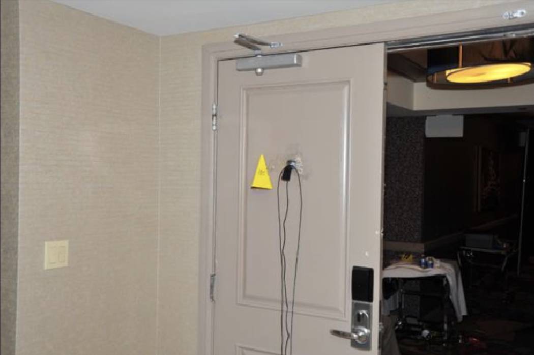 A surveillance camera mounted to the peephole of the room door. LVMPD.