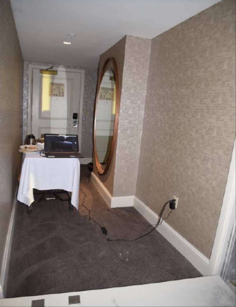The hallway of room 32-134 with a food service cart and laptop connected to cameras in the hallway. LVMPD.
