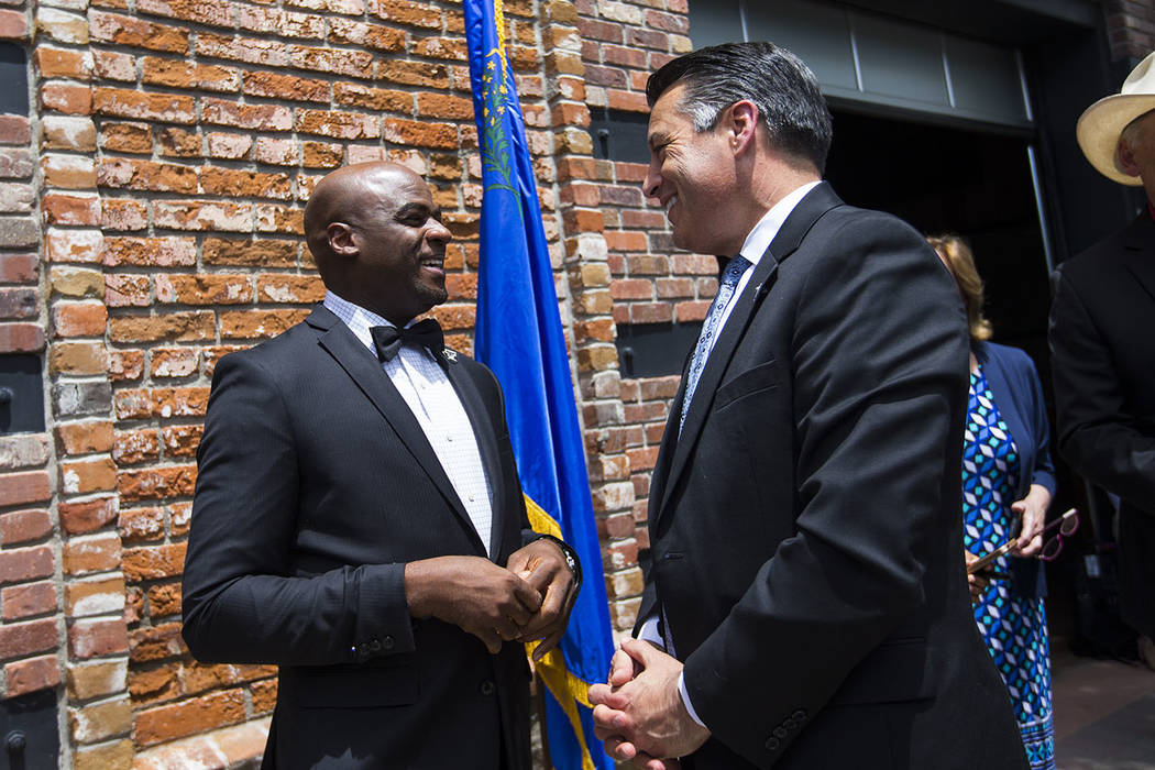 Sen. Kelvin Atkinson, D-North Las Vegas, left, talks with Gov. Brian Sandoval at The Union restaurant and brewery in Carson City on Monday, June 5, 2017. Chase Stevens Las Vegas Review-Journal @cs ...
