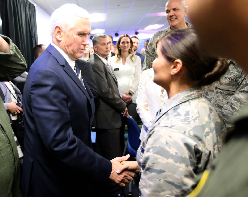 Vice President Mike Pence shakes hands with Capt. K. Austin DeLorme at the grand opening of AFWERX Vegas, a work space for the Air Force program that fosters entrepreneurial innovation engagements ...