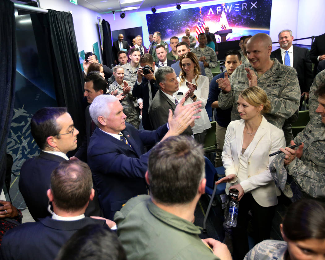 Vice President Mike Pence applauds airmen and their families at the grand opening of AFWERX Vegas, a work space for the Air Force program that fosters entrepreneurial innovation engagements. The i ...