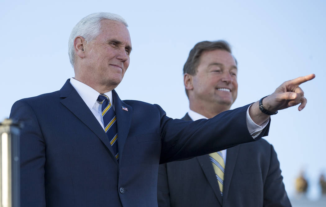 United States Vice President Mike Pence, left, and Nevada Senator Dean Heller acknowledge the crowd before speaking to airmen during visit to Nellis Air Force Base near Las Vegas, Nevada on Thursd ...