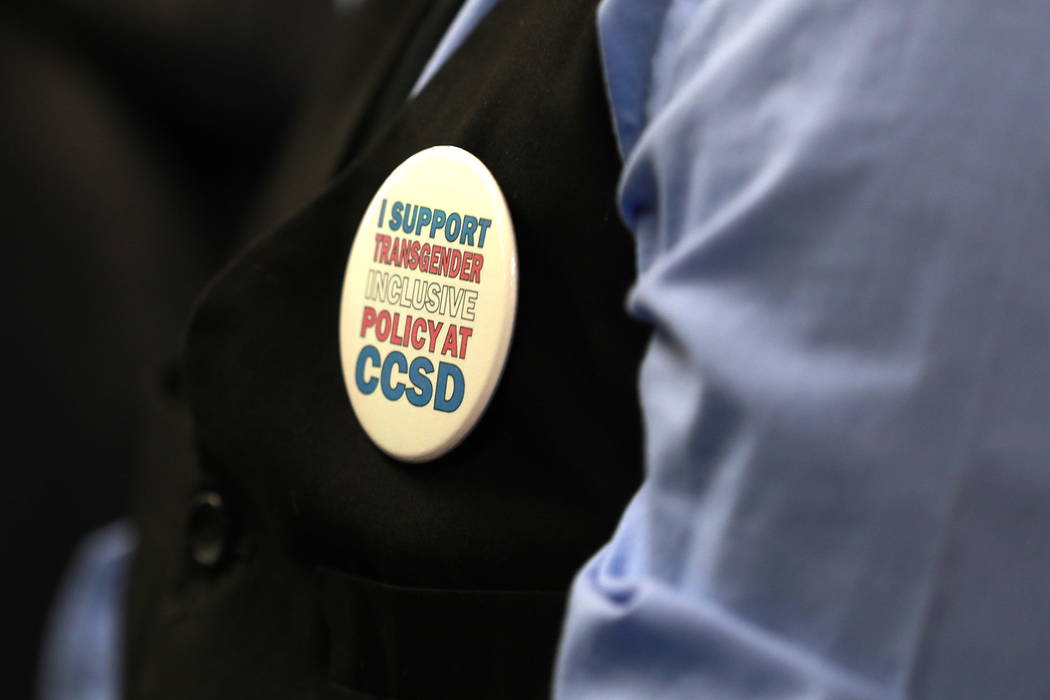 An attendee wears a pin in support of  gender-diverse policy during a Clark County School Board meeting, which ended with the board pulling the controversial policy from the agenda, at the Edward  ...