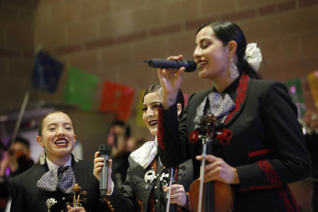 Mayra Orellana, 17, from left, Monica Salinas, 17, and Yasmine Duenes, 21, sing as part of the Mariachi Herencia de Las Vegas at Canyon Spring High School in North Las Vegas, Friday, March 9, 2018 ...