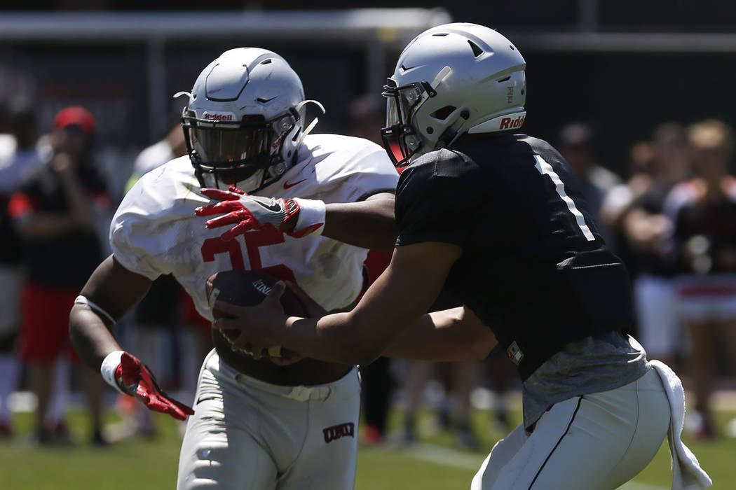 UNLV'S quarterback Armani Rogers (1) hands off the ball to running back Xzaviar Campbell (35) during the first quarter of UNLV's spring football game at the Peter Johann Memorial Field in Las Vega ...
