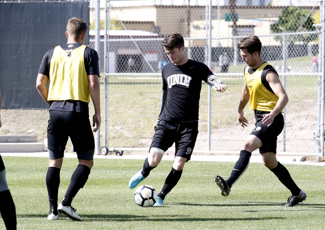 UNLV soccer midfielder Austin Manthey, center, kicks the ball between Adam Musovski, right, and Timo Mehlich during practice on Wednesday, April 18, 2018, in Las Vegas. Bizuayehu Tesfaye/Las Vegas ...