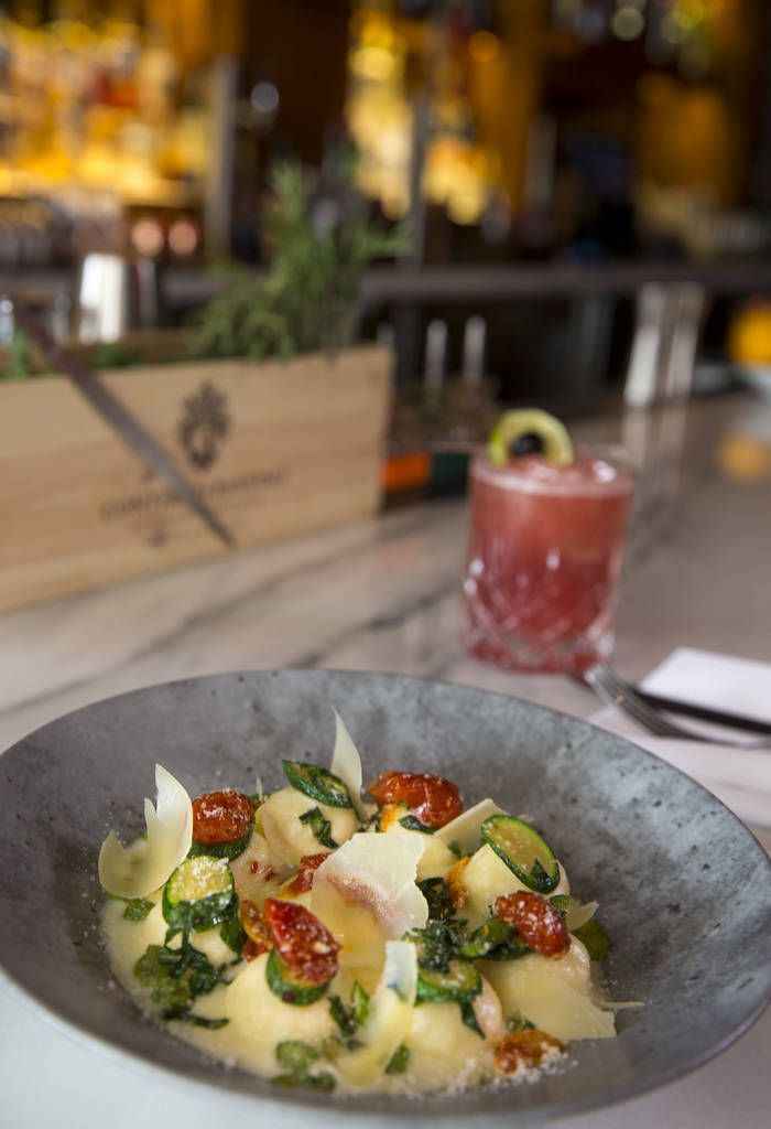 Ricotta and mascarpone cheese gnudi and primavera style vegetables served with a Toscano Sunset at Masso Osteria inside Red Rock Casino in Las Vegas on Monday, May 21, 2018. Richard Brian Las Vega ...