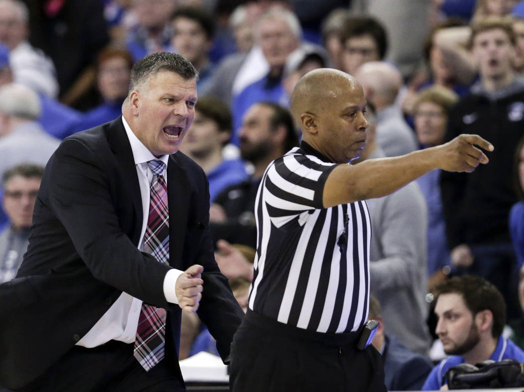 Creighton coach Greg McDermott, left, protests a call against his team to referee Lamar Simpson, during the second half of an NCAA college basketball game in Omaha, Neb., Saturday, Feb. 24, 2018. ...