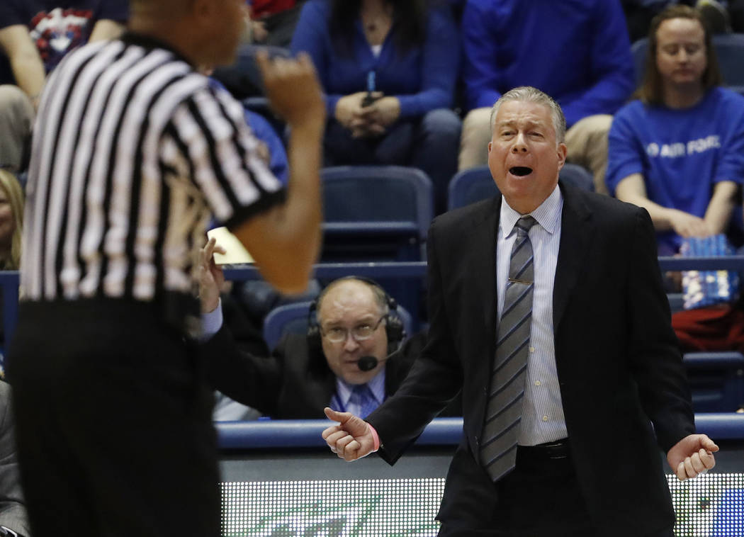 Air Force head coach Dave Pilipovich, right, reacts to a call against his team in the second half of an NCAA college basketball game against Utah State, Saturday, Feb. 24, 2018, at Air Force Acade ...