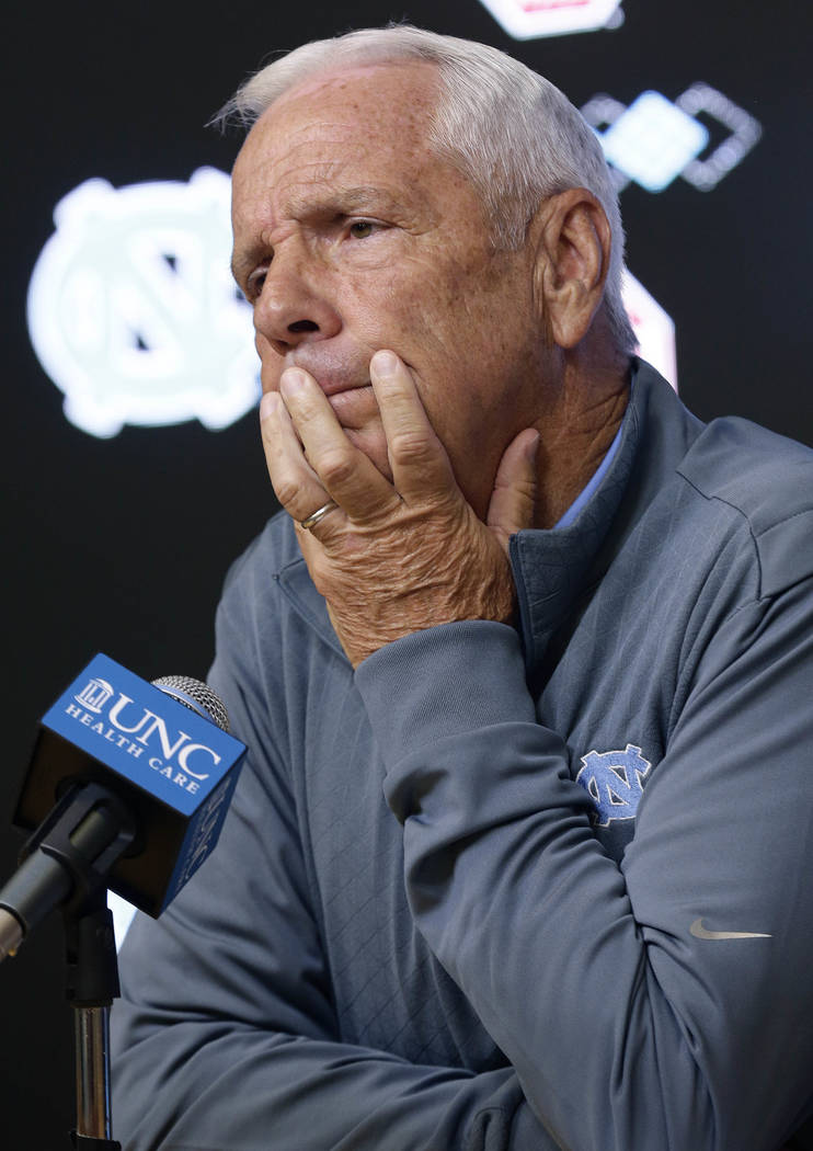 North Carolina NCAA basketball coach Roy Williams takes questions from members of the media during a news conference in Chapel Hill, N.C., Tuesday, June 12, 2018. (AP Photo/Gerry Broome)