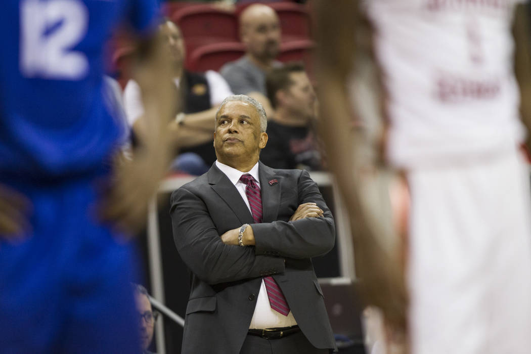 UNLV Rebels head coach Marvin Menzies talks to his team in their game against Air Force Falcons in the second half of the Mountain West Conference men's basketball tournament game at the Thomas &a ...
