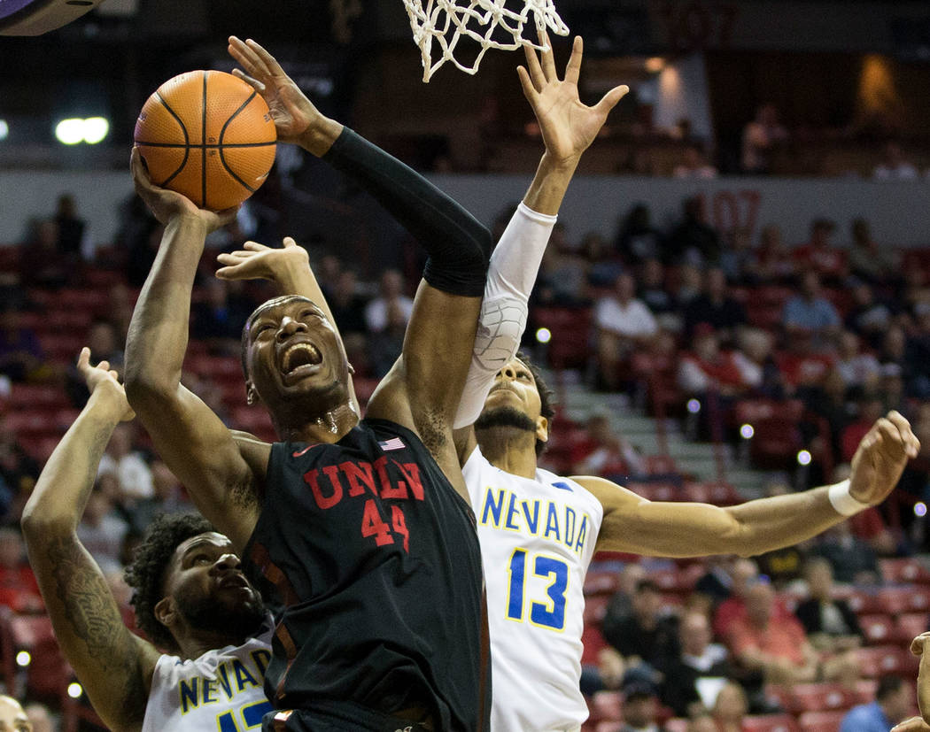 UNLV Rebels forward Brandon McCoy (44) goes up for a shot under pressure from Nevada Wolf Pack forward Elijah Foster (12) and guard Hallice Cooke (13) in the first half of the Mountain West Confer ...