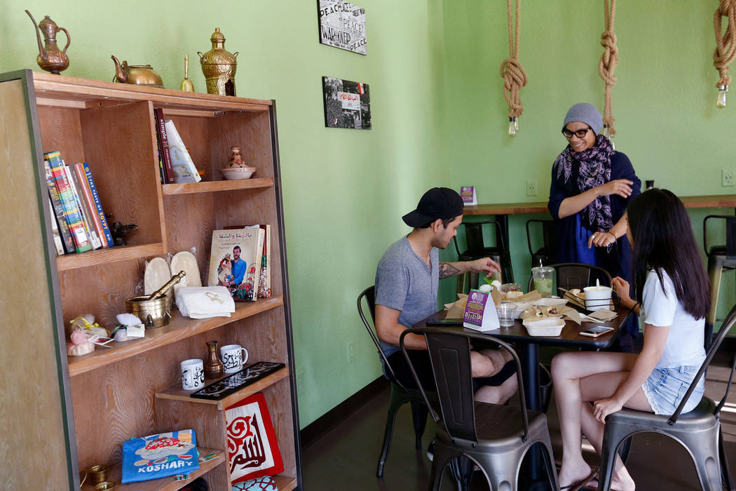 Pots owner/chef Iman Haggag, center, speaks to her customers Gray Murillo of Las Vegas and his wife Kalei Nishimura at the restaurant in Las Vegas, Thursday, June 7, 2018. Pots is a vegan and vege ...