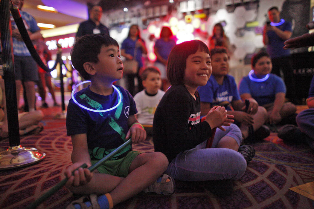 Analu Tam, 6, left, and his sister Kailana Tam, 9, laugh during a drum circle activity at the Luxor hotel-casino in Las Vegas, Sunday, June 10, 2018. The event took place before the Blue Man Group ...