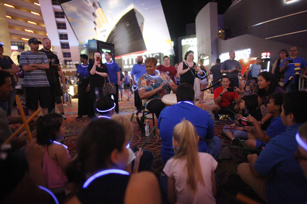 Linda Austin, known as "La", a Smith Center master teacher artist, leads a drum circle at the Luxor hotel-casino in Las Vegas, Sunday, June 10, 2018. The event took place before the Blue ...