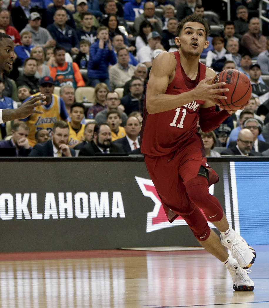 In this March 15, 2018, file photo, Oklahoma's Trae Young drives to the hoop during overtime of an NCAA men's college basketball tournament first-round game against Rhode Island,in Pittsburgh. (AP ...