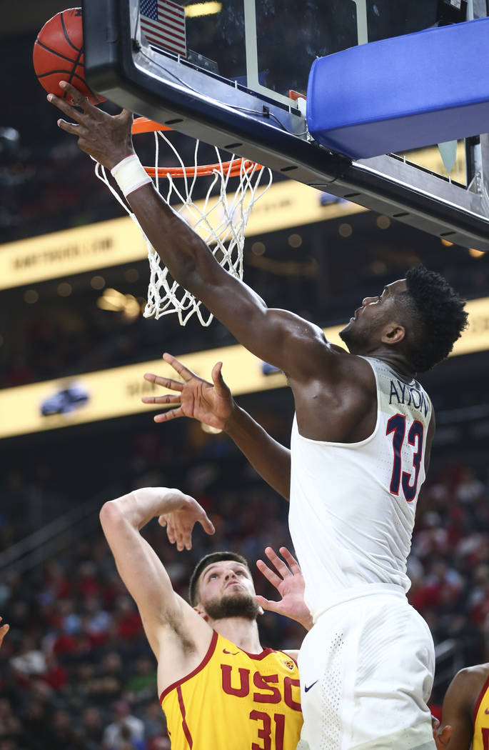 Arizona Wildcats forward Deandre Ayton (13) goes to the basket against USC Trojans forward Nick Rakocevic (31) during the Pac-12 tournament championship basketball game at T-Mobile Arena in Las Ve ...