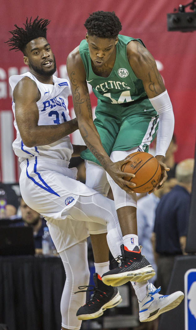 Boston Celtics center Robert Williams (44) grabs a rebound over Philadelphia 76ers center Norvel Pelle (31) during NBA Summer League on Friday, July 6, 2018, at the Thomas & Mack Center, in La ...