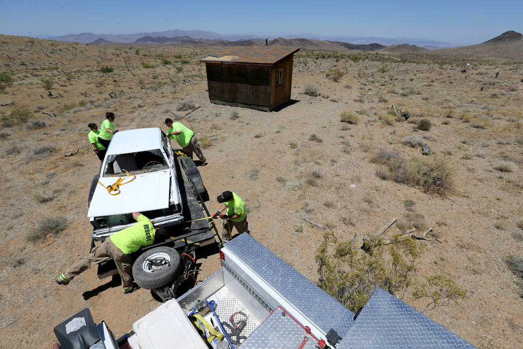 Motor Sports Safety Solutions team members recover a car that belonged to the late Las Vegas Sh ...