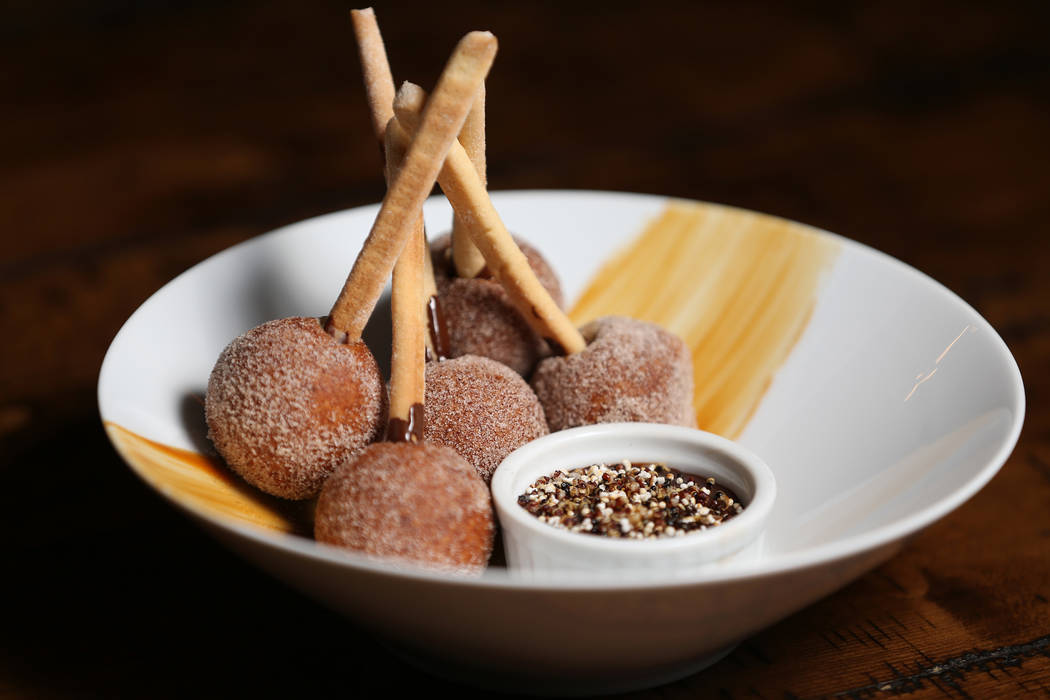 The churro bon bons filled with white chocolate, milk chocolate and dulce de leche, at Once restaurant at the Palazzo hotel-casino in Las Vegas, Wednesday, Aug. 1, 2018. Erik Verduzco Las Vegas Re ...