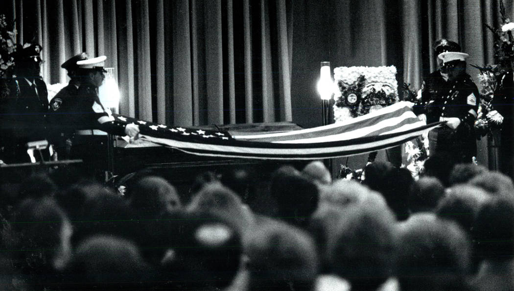 Members of the Marine Corps fold a flag over the casket of slain FBI Agent John Bailey at Palm ...