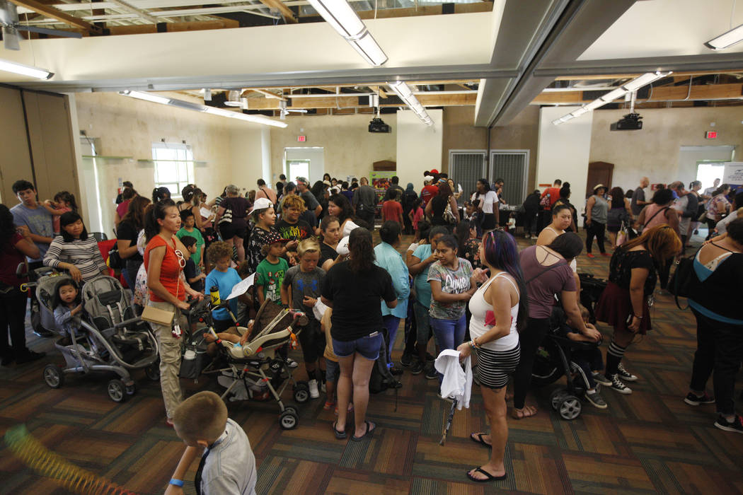 Families wait in line at the annual Back to School Fair organized by the Happy Face Foundation at Springs Preserve in Las Vegas, Sunday, Aug. 5, 2018. Students received free school supplies as wel ...