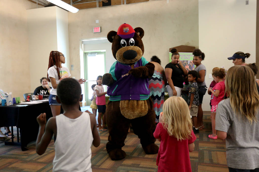 Incredibear from John's Incredible Pizza Company dances with kids at the annual Back to School Fair organized by the Happy Face Foundation at Springs Preserve in Las Vegas, Sunday, Aug. 5, 2018. S ...