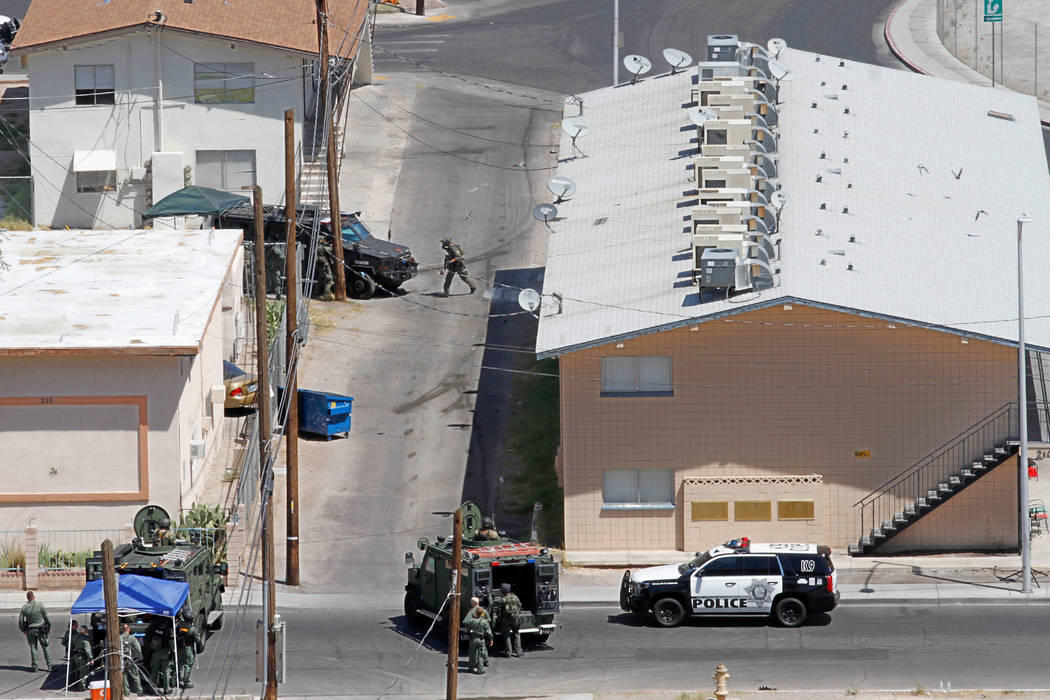 Las Vegas police and a SWAT team are seen around Baltimore Avenue in Las Vegas, Saturday, Aug. 4, 2018. According to Las Vegas police, a man barricaded inside of a downtown Las Vegas home early Sa ...