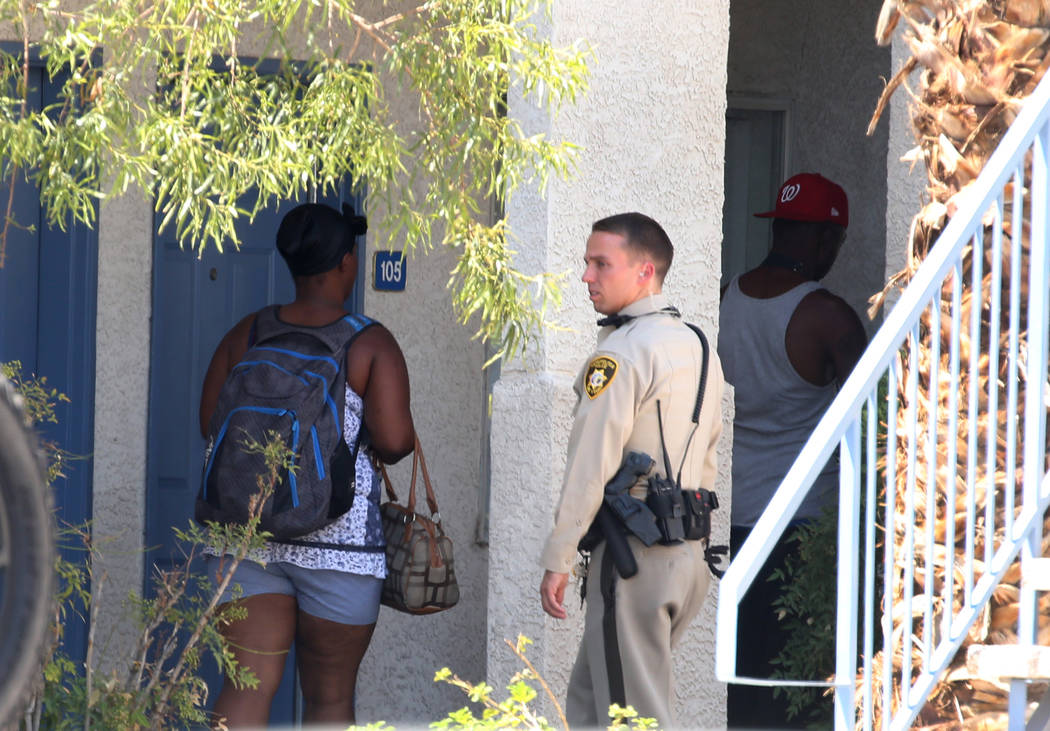 Residents at Kensington Suites in the 2200 block of West Bonanza Road watch as Las Vegas police are investigating an officer-involved shooting, Monday, Aug. 6, 2018. It's the third officer-involve ...