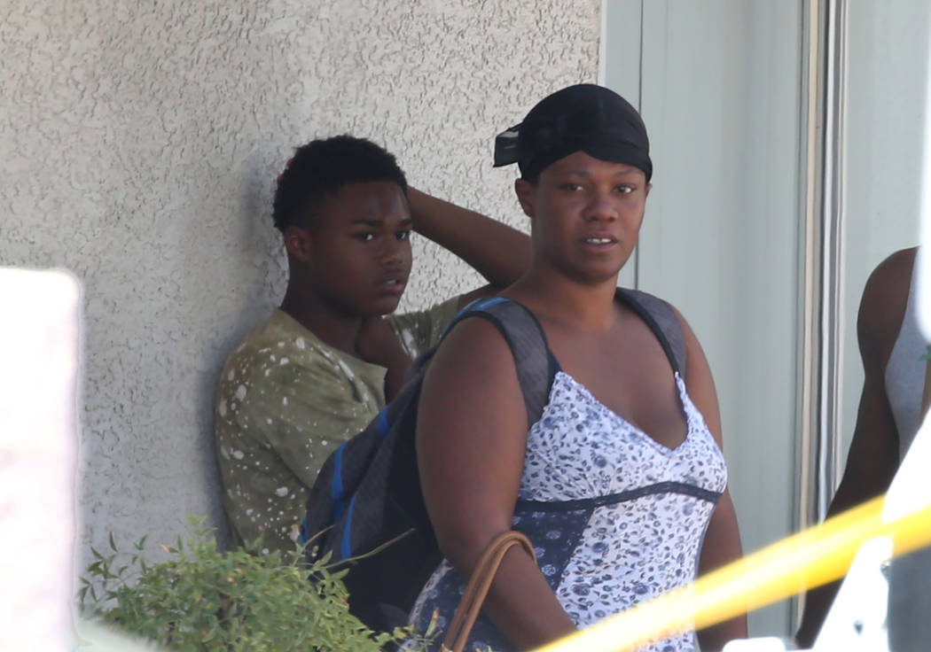 Residents at Kensington Suites in the 2200 block of West Bonanza Road watch as Las Vegas police are investigating at the scene of an officer-involved shooting, Monday, Aug. 6, 2018. It's the third ...
