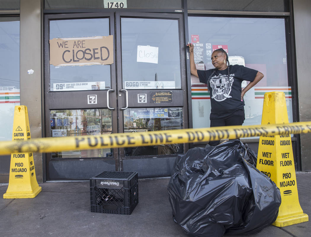 711 cashier Gilda Cook takes a break from throwing out produce that was lost after power was knocked out at the convenience store on Fremont Street and Bruce Street on Sunday, Aug., 12, 2018, in L ...