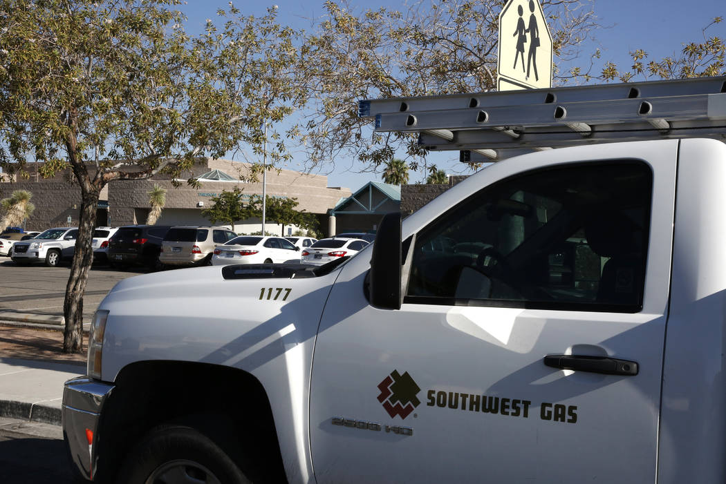 A Southwest Gas truck is parked outside of Swainston Middle School after students and staff were evacuated from the building after a reported gas leak Friday morning, Aug. 17, 2018, in North Las V ...