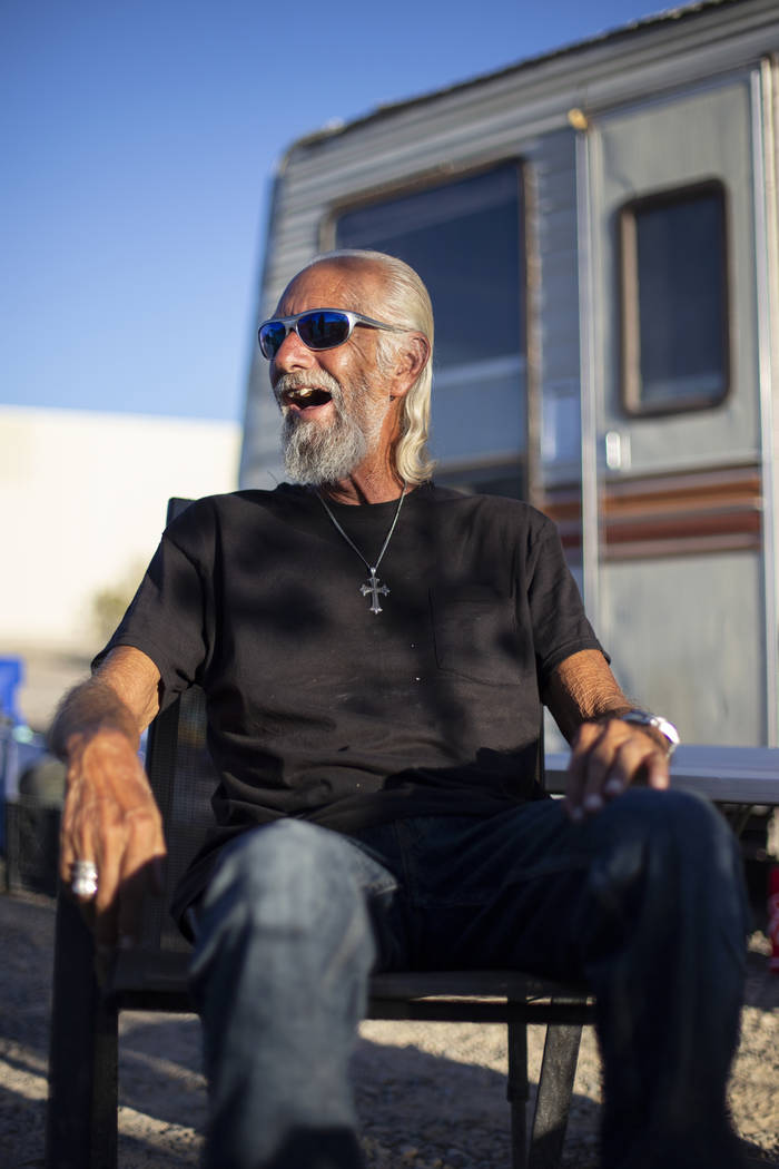Homeless resident Rich enjoys a beverage outside of his trailer that sits on a lot west of the ...