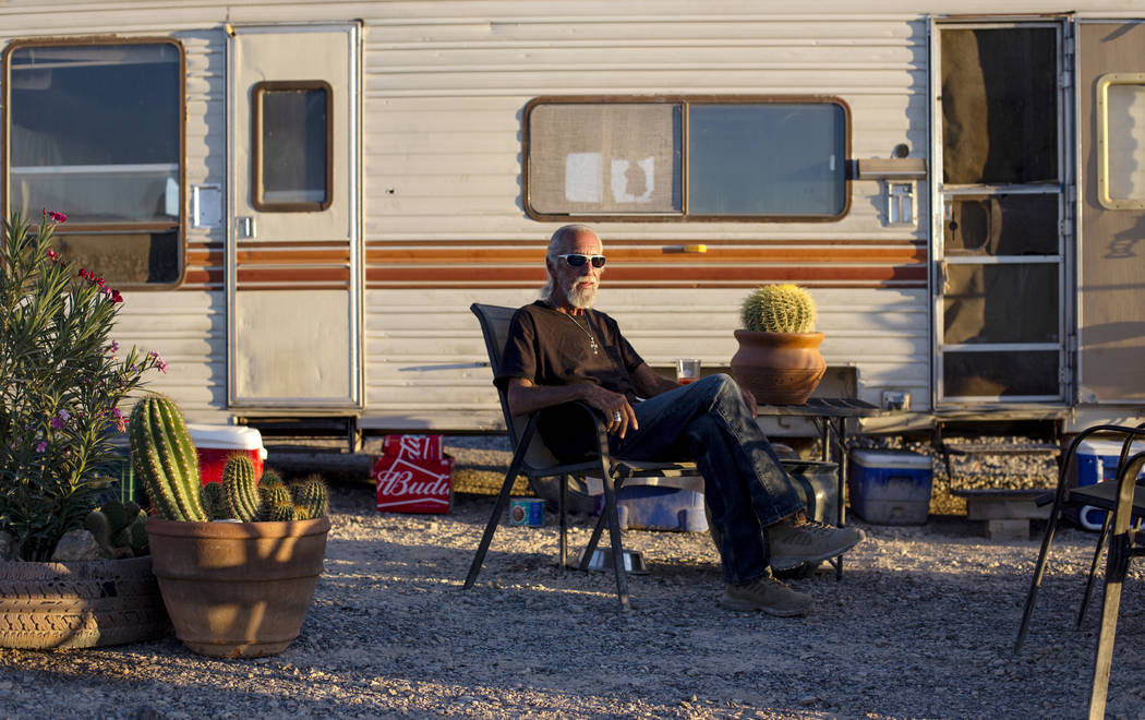 Homeless resident Rich poses for a photograph outside of his trailer that sits on a lot west of ...