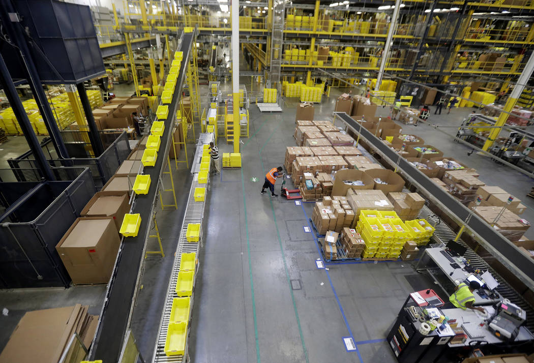 Employees work at the Amazon Fulfillment center in Robbinsville Township, N.J., Aug. 1, 2017. A ...