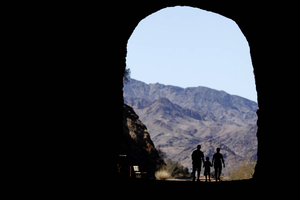 A family walks through a tunnel on the Historic railroad Trail in the Lake Mead National Recrea ...