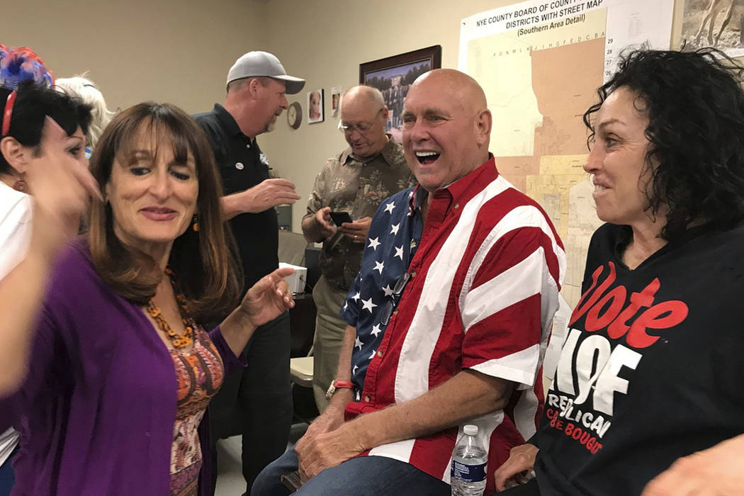 Nevada brothel owner Dennis Hof, second from right celebrates in Pahrump after winning the Republican primary election for Nevada Assembly District 36, Tuesday, June 12, 2018. Hof is the owner of ...
