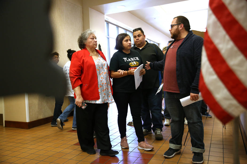 Ana Murrieta, 66, from left, her granddaughter Aremy Tirado, 18, and her sons Leohabin Murrieta, 34, and Leonel Murrieta, 32, wait in line to vote at the East Las Vegas Community Center in Las Veg ...