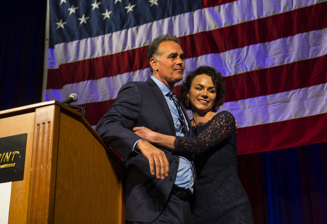 Amy Tarkanian comforts her husband Danny Tarkanian, Republican candidate for the 3rd Congressional District, after he conceded to Democratic candidate Susie Lee during the Nevada Republican Party ...