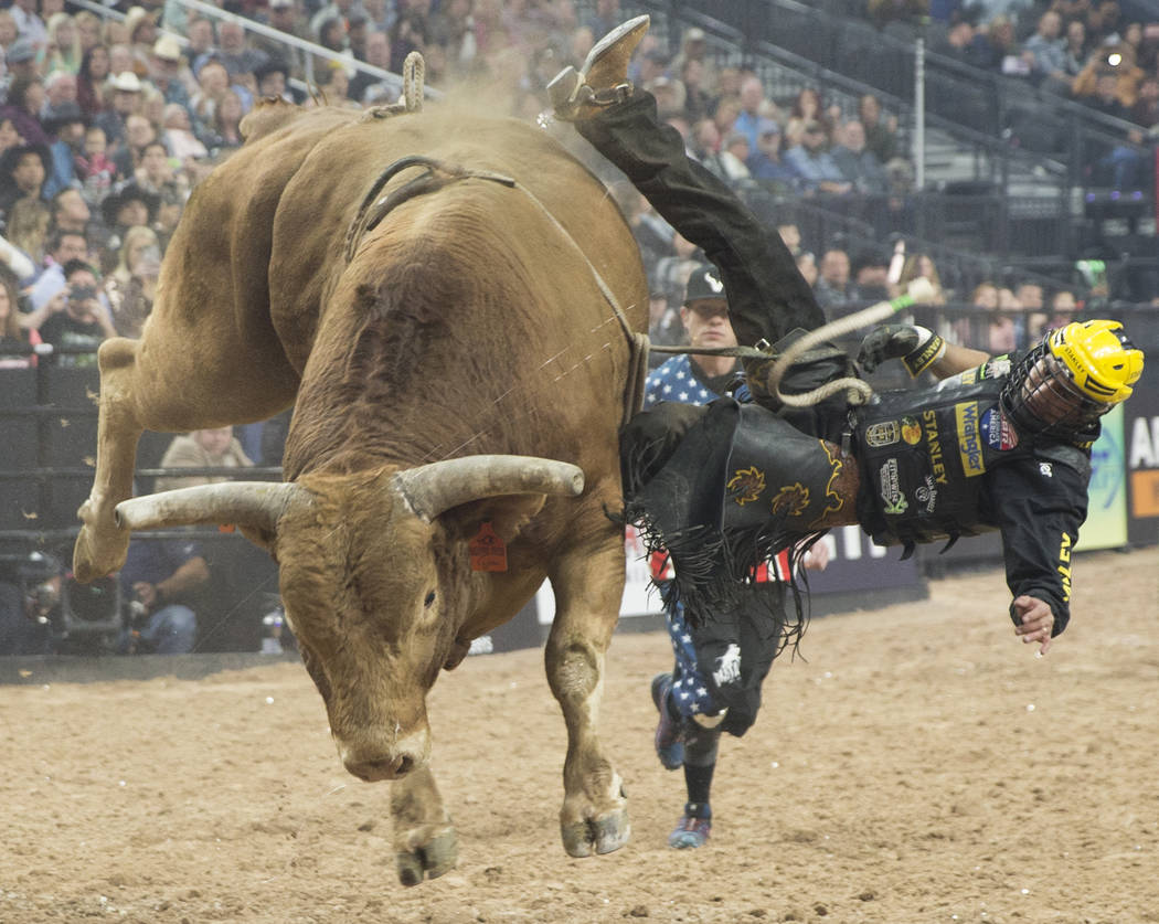 Silvano Alves gets thrown off of "Beaver Creek Beau" during the Professional Bull Riders World Finals on Thursday, November 8, 2018, at T-Mobile Arena, in Las Vegas. Benjamin Hager Las V ...