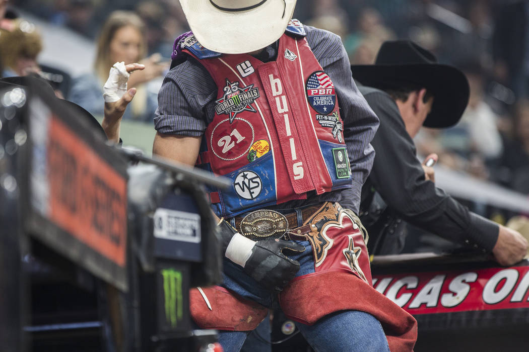Allisson De Souza gets ready to ride "Lester Gillis" during the Professional Bull Riders World Finals on Thursday, November 8, 2018, at T-Mobile Arena, in Las Vegas. Benjamin Hager Las V ...