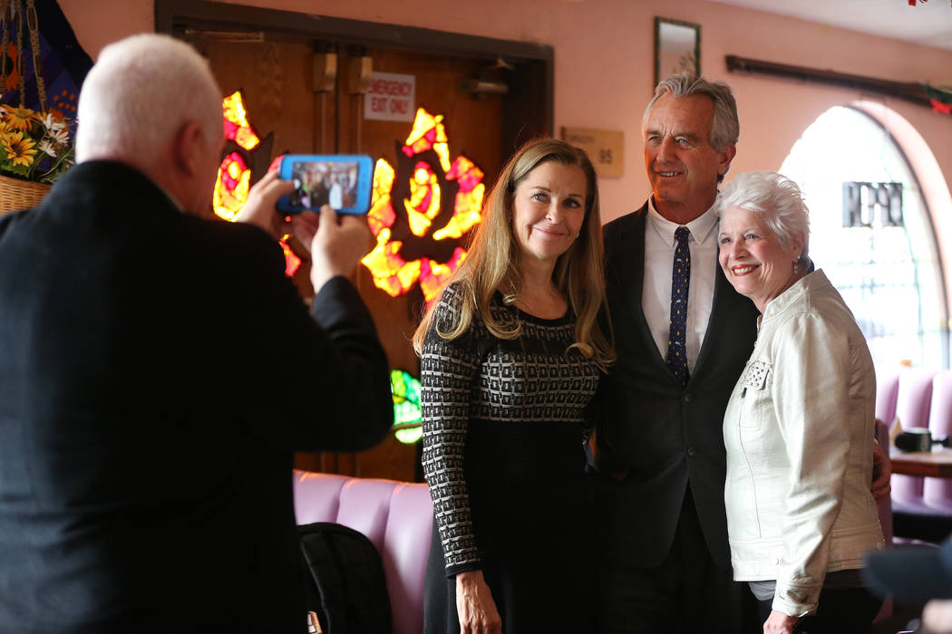 Bobby Kennedy Jr., center, Waterkeeper Alliance president, takes a photo with Pauline van Bette, left, and Marsala Rypka, during a kick-off event for the Las Vegas affiliate chapter of the Colora ...
