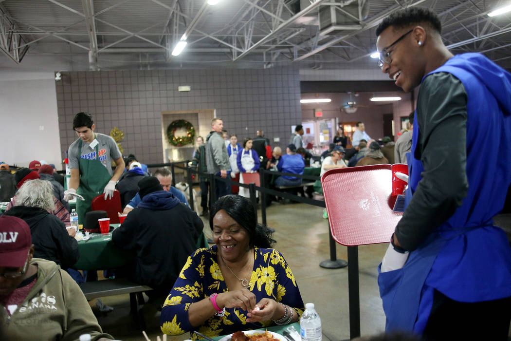 Donovan Smith, 17, laughs with Laurice Adams at the Christmas meal sponsored by the Frank and Victoria Fertitta Foundation, at Catholic Charities of Southern Nevada in Las Vegas, Sunday, Dec. 16, ...