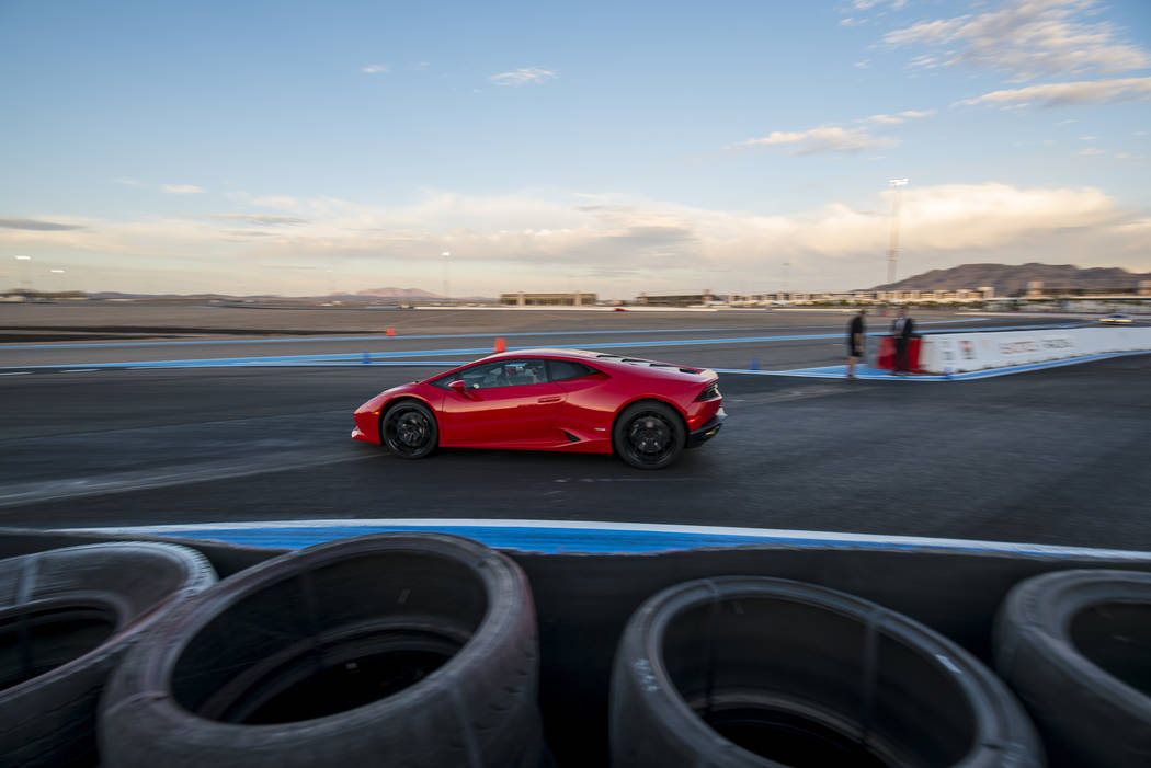Invited guests receive rides in luxury sports cars at Exotics Racing during the grand opening of the new welcome center at Las Vegas Motor Speedway in Las Vegas on Thursday, June 4, 2015. (Joshua ...