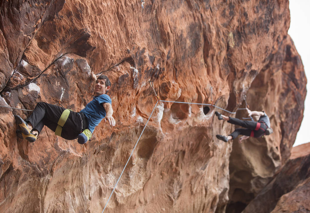 Alex Honnold, left, ascends The Gallery at Red Rock Canyon on Monday, Dec. 17, 2018, in Las Veg ...