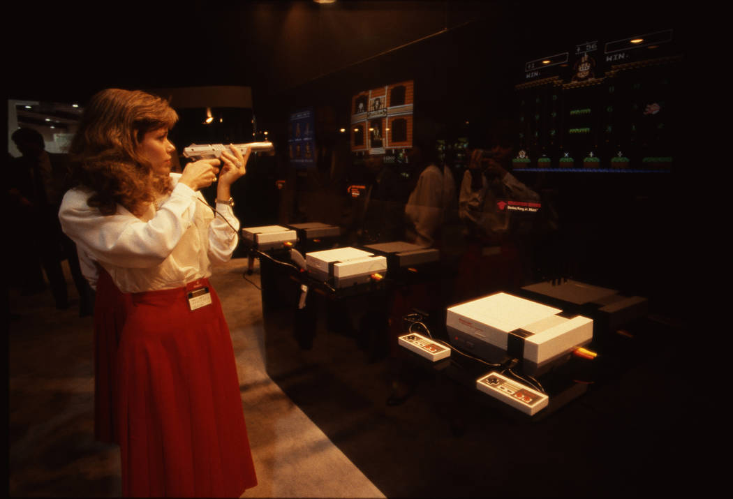A woman plays a video game on an NES console at the 1987 CES show at the Las Vegas Convention Center. (Jim Laurie/Las Vegas Review-Journal)