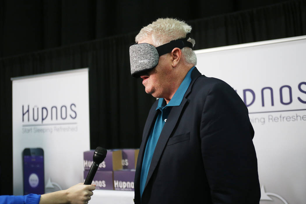 Curtis Ray, founder of HYpnos, speaks to media while wearing the device that is a self-learning snore-reduction mask at the CES Unveiled event for media prefacing the tech mega-conference at Manda ...